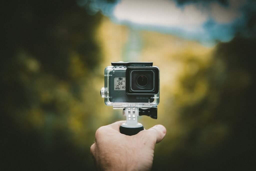 A rider using an action camera while biking on a scenic trail, capturing the adventure and surroundings.