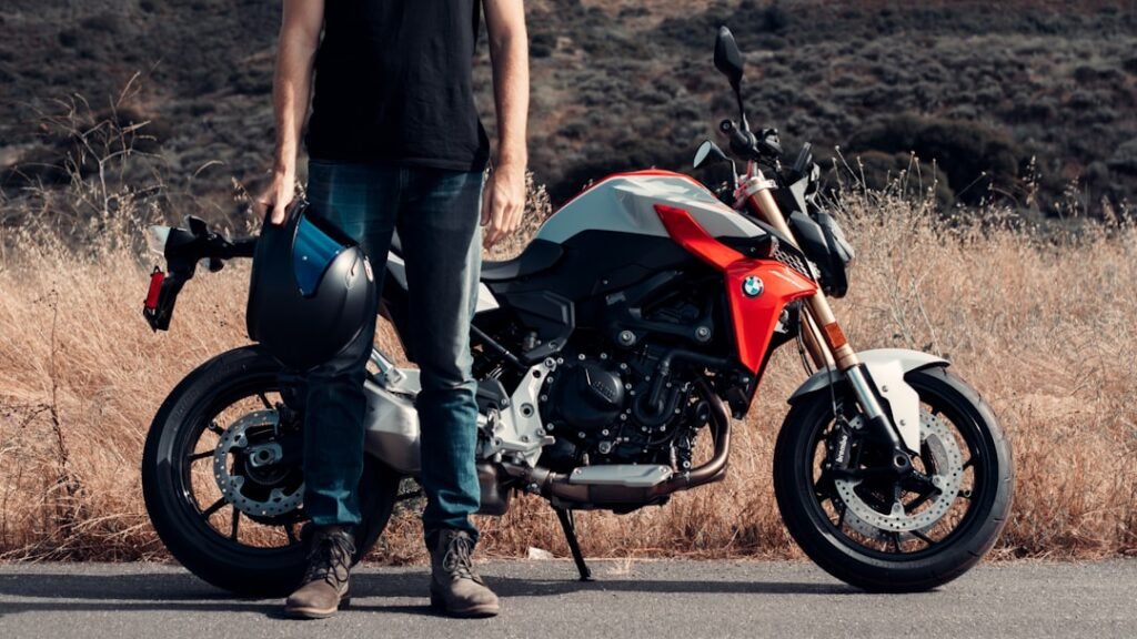A close-up of sturdy motorcycle boots on a road, showcasing their protective features and rugged design.