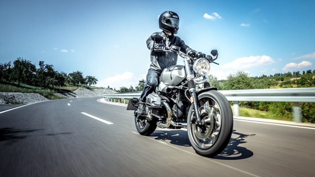A new motorcycle rider practicing cornering techniques on a winding road, focusing on body positioning and bike control.