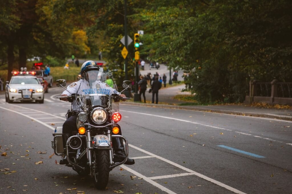 A new motorcycle rider practicing safety techniques on a motorcycle in a safe environment.