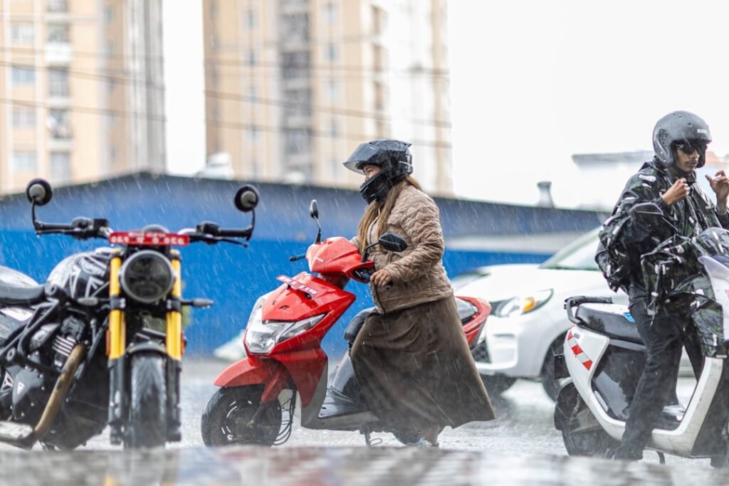 A motorcyclist riding confidently through rain on a wet road, showcasing proper gear and techniques for safe riding.