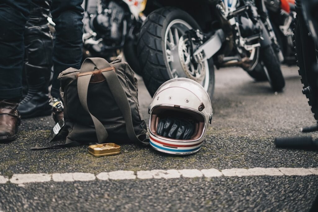 A motorcycle parked with various types of luggage attached, showcasing different styles and capacities.