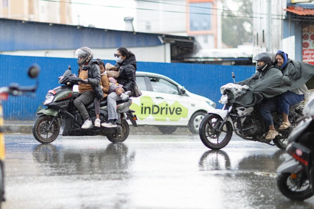 A motorcycle navigating a wet road during rain, showcasing the challenges of riding in adverse weather conditions.
