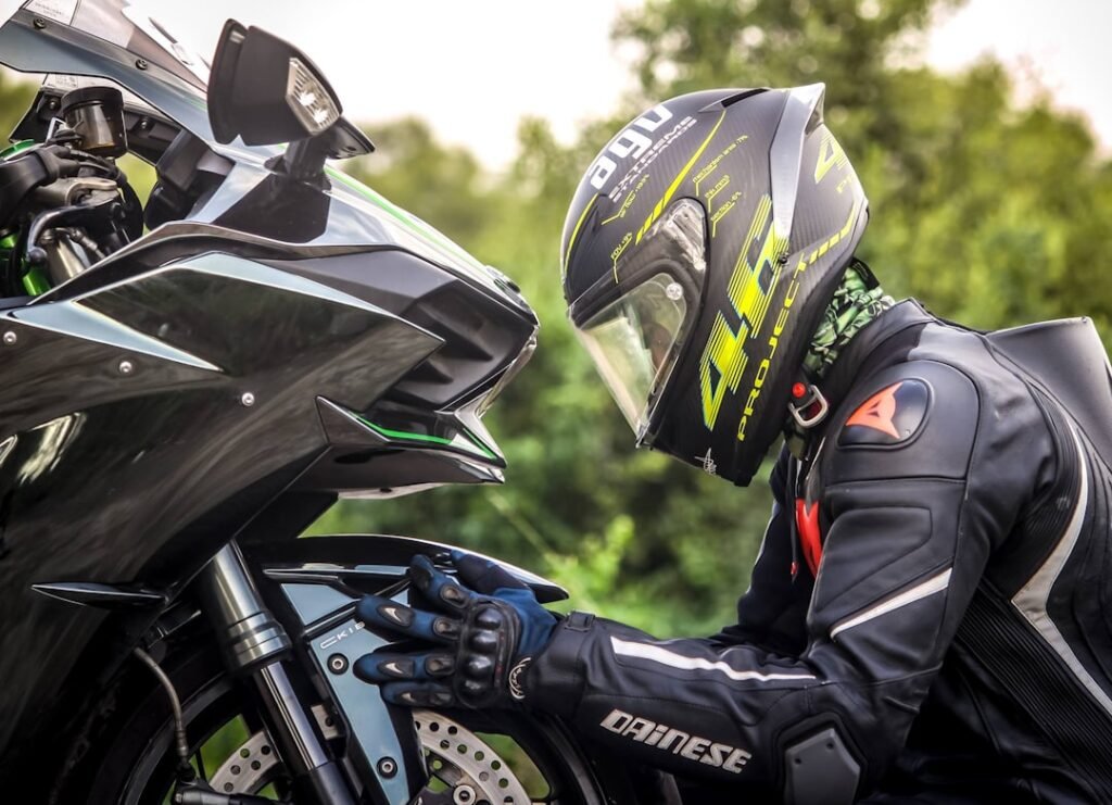 A collection of motorcycle accessories including helmets, gloves, and bags displayed on a bike.