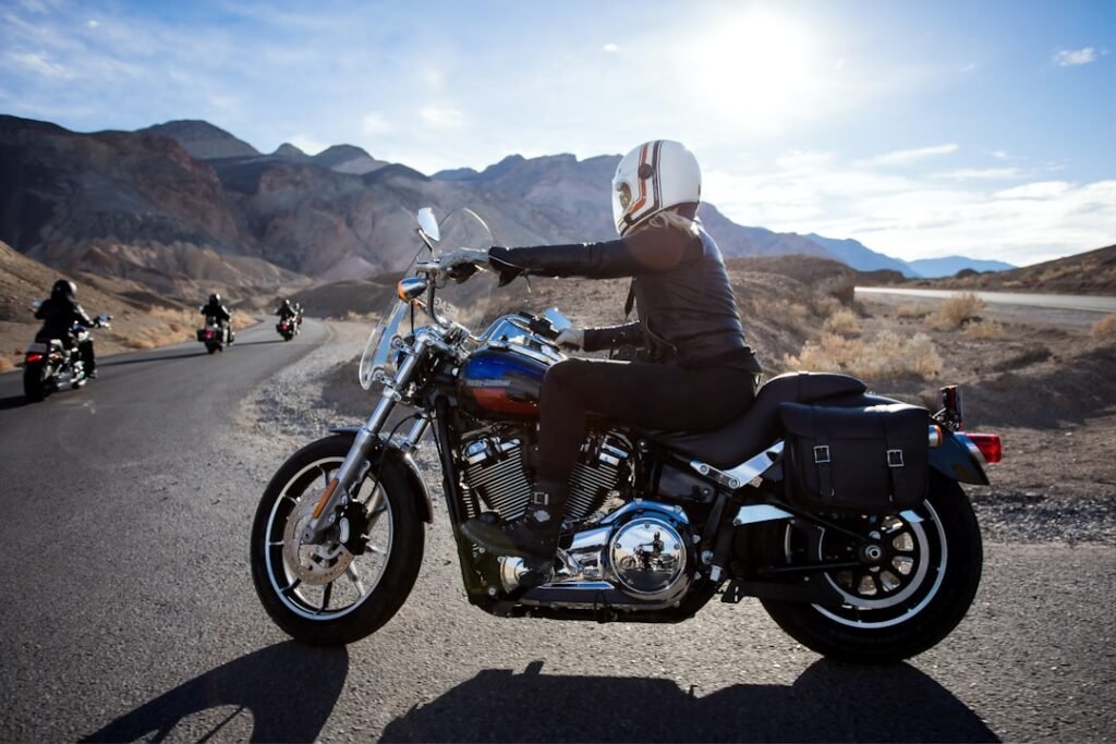 A motorcycle parked with various types of luggage attached, showcasing different mounting techniques and styles suitable for riders.